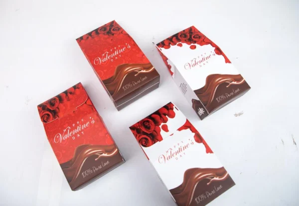 Valentine's Day chocolate gift boxes by Sekoe Chocolates, featuring red and white designs with roses and flowing chocolate, labeled "100% Pure Love